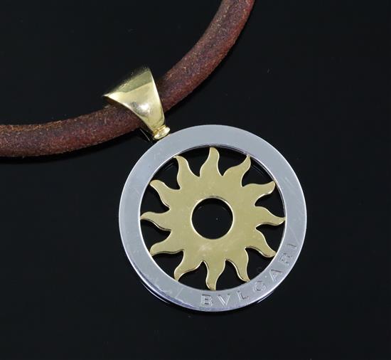 A 20th century Italian 18ct gold and steel Bulgari pendant, on a fabric necklet with Bulgari clasp, gross 27.2 grams.